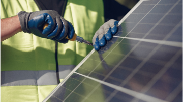 A worker installing a solar panel.
